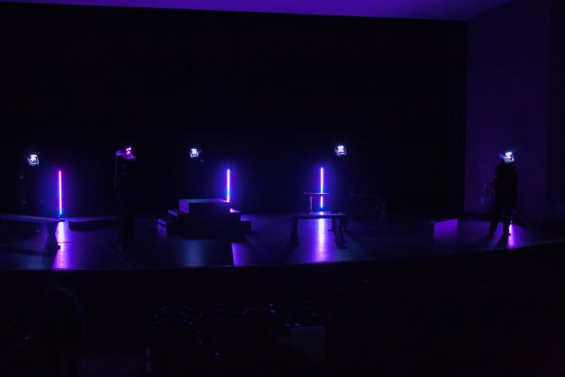 Actors on stage with helmet lights on